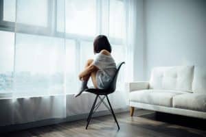 attachment theory - woman sitting alone in a room