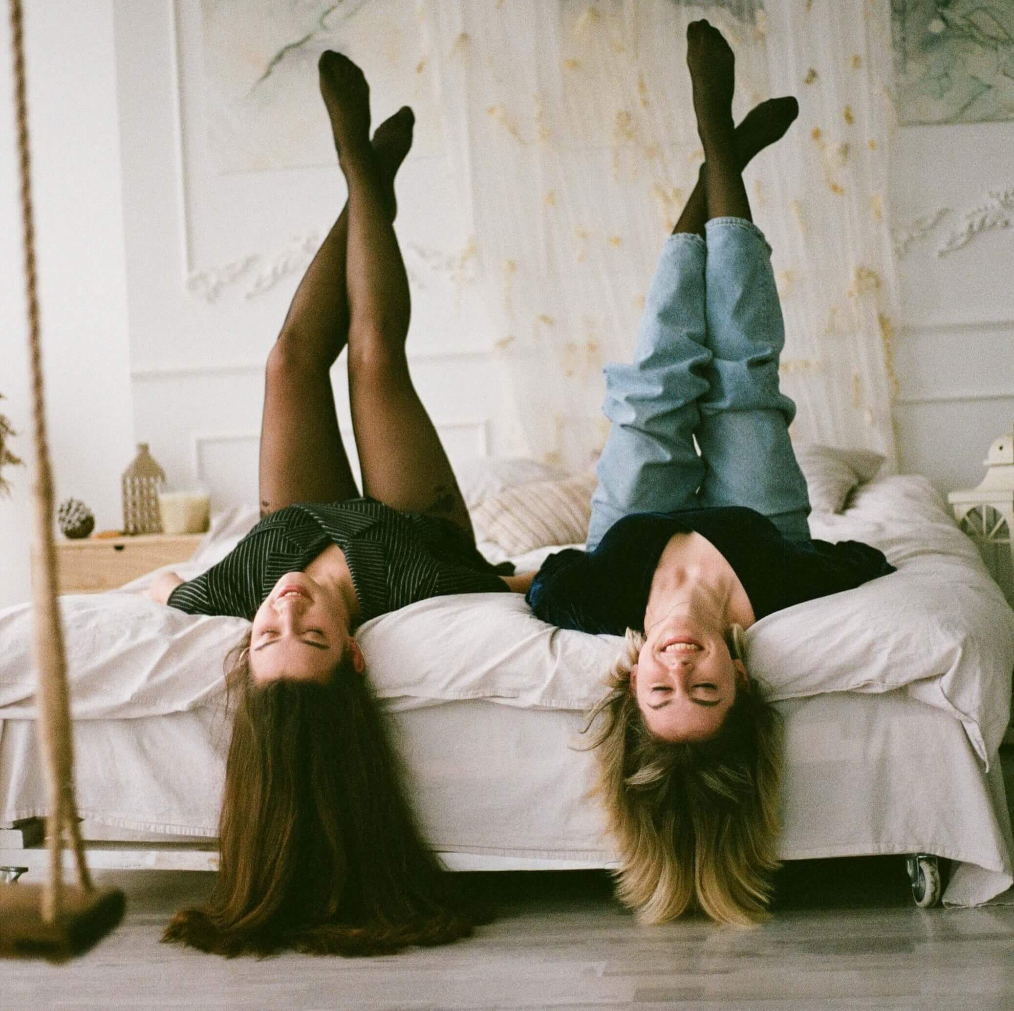 Two girls smiling in bed