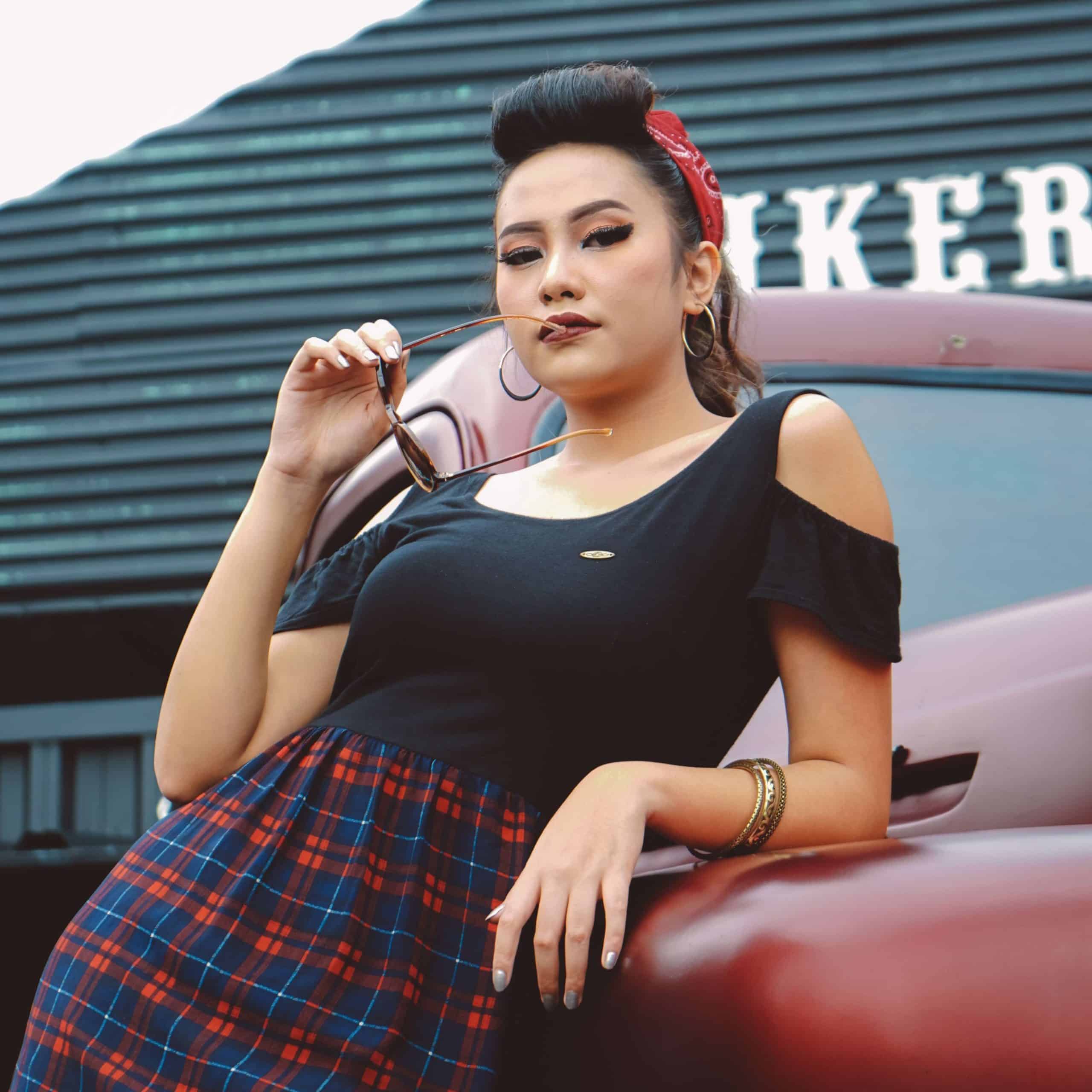 Maladaptive Schemas: Grandiosity: confident woman leaning on a classic car