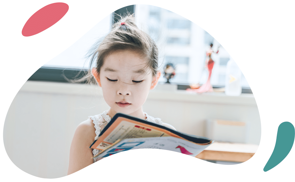 little girl looking at a book